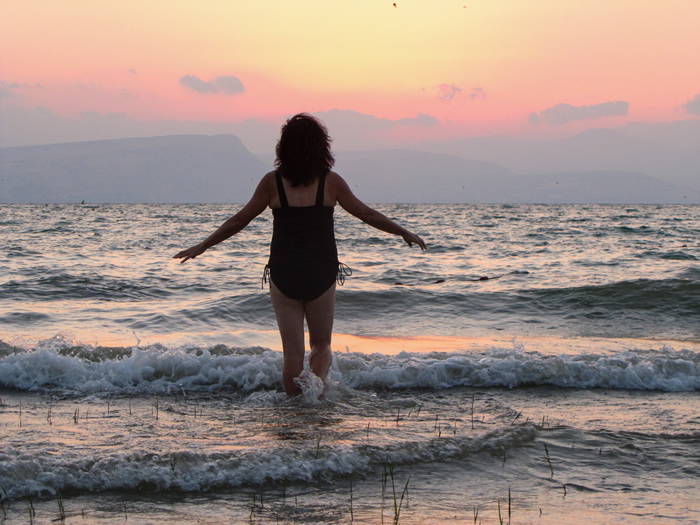 Toni walks into the Sea of Galilee at En Gev at sundown